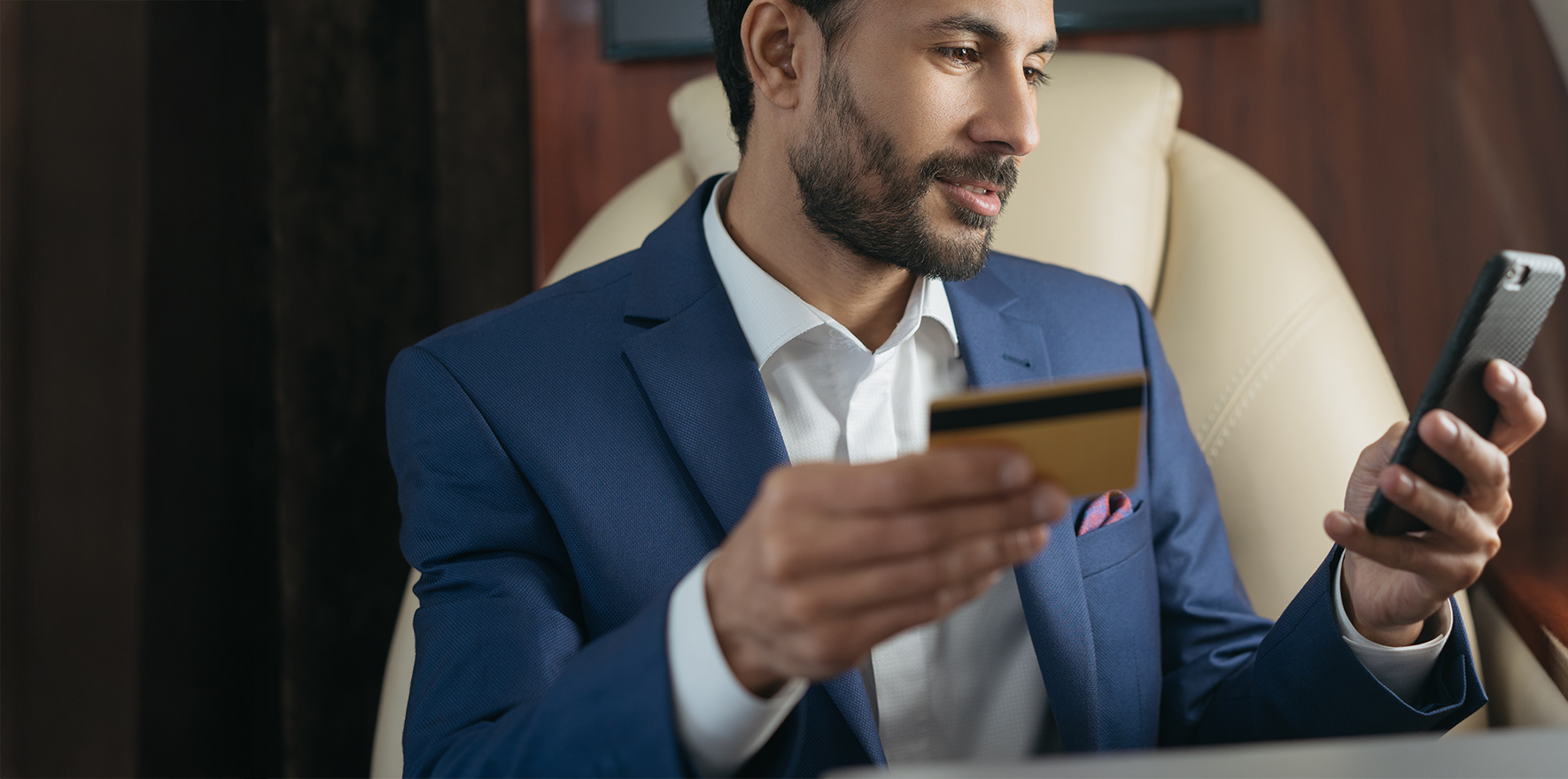 Man holding credit card and phone