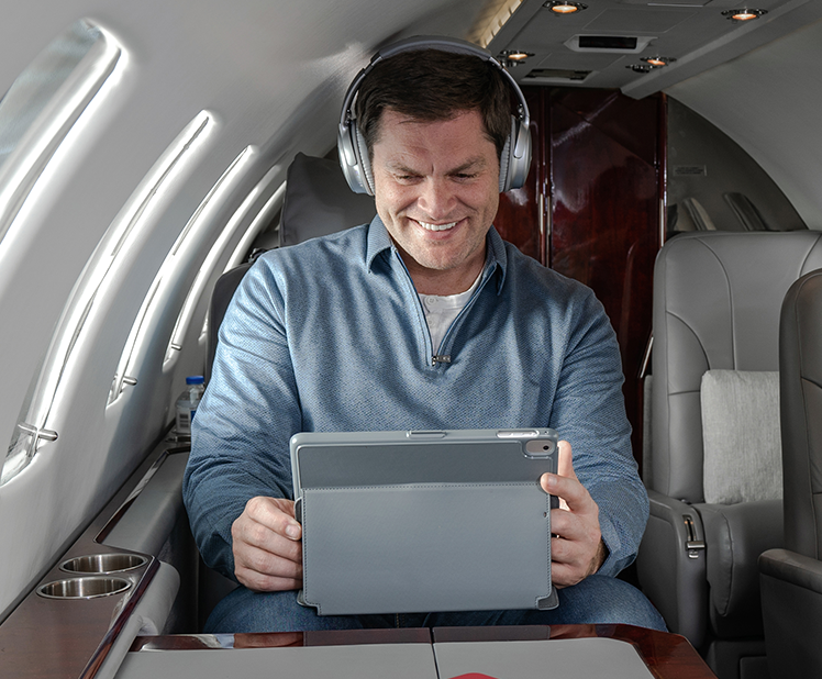 man on ipad smiling