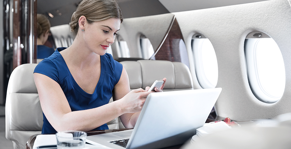 Woman on plane on devices
