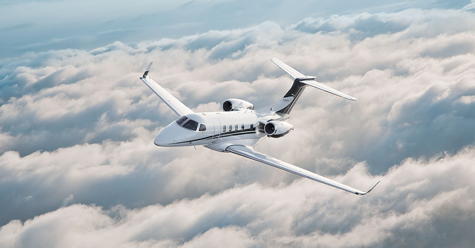 Embraer Phenom 300 Flying Over Clouds