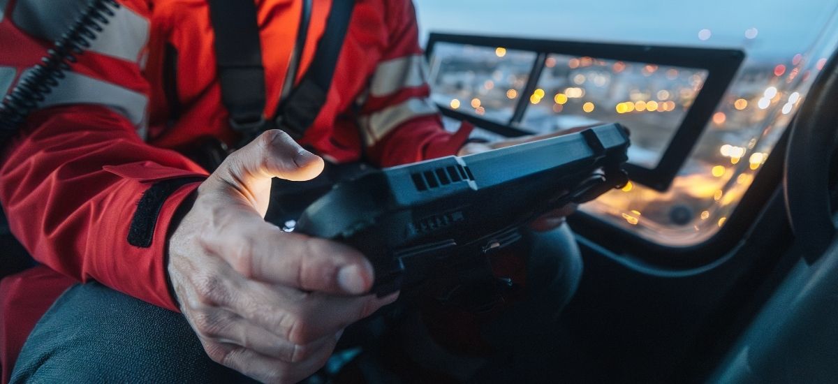 Emergency responder using rugged tablet inside transport vehicle