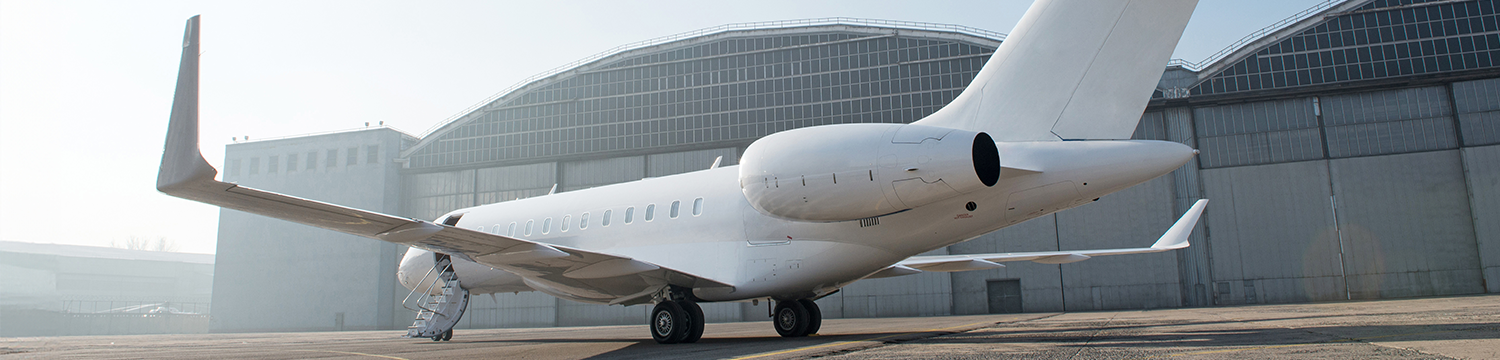 White Bombardier Global 6000 in front of hangar White Bombardier Global 6000 in front of hangar
