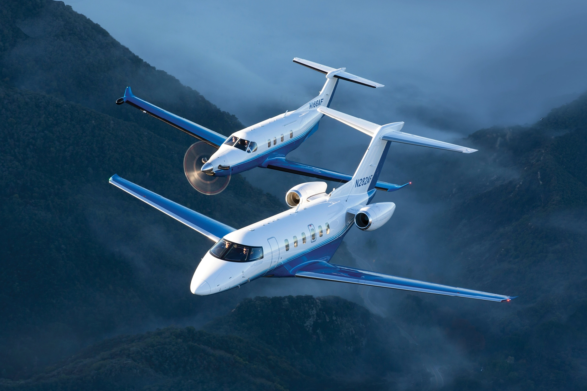 Pilatus PC-12 and PC-24 in air over mountains