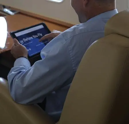Man on iPad in cabin Man on iPad in cabin