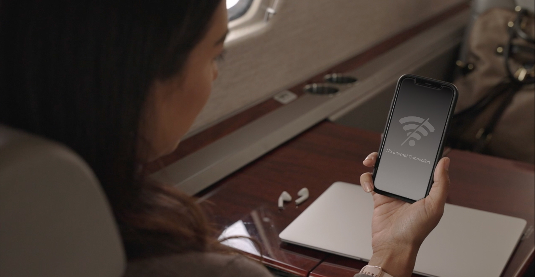 Woman holding phone no internet signal