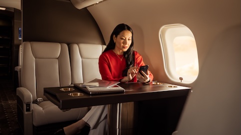 Teaser - Woman in red shirt looking at phone in cabin