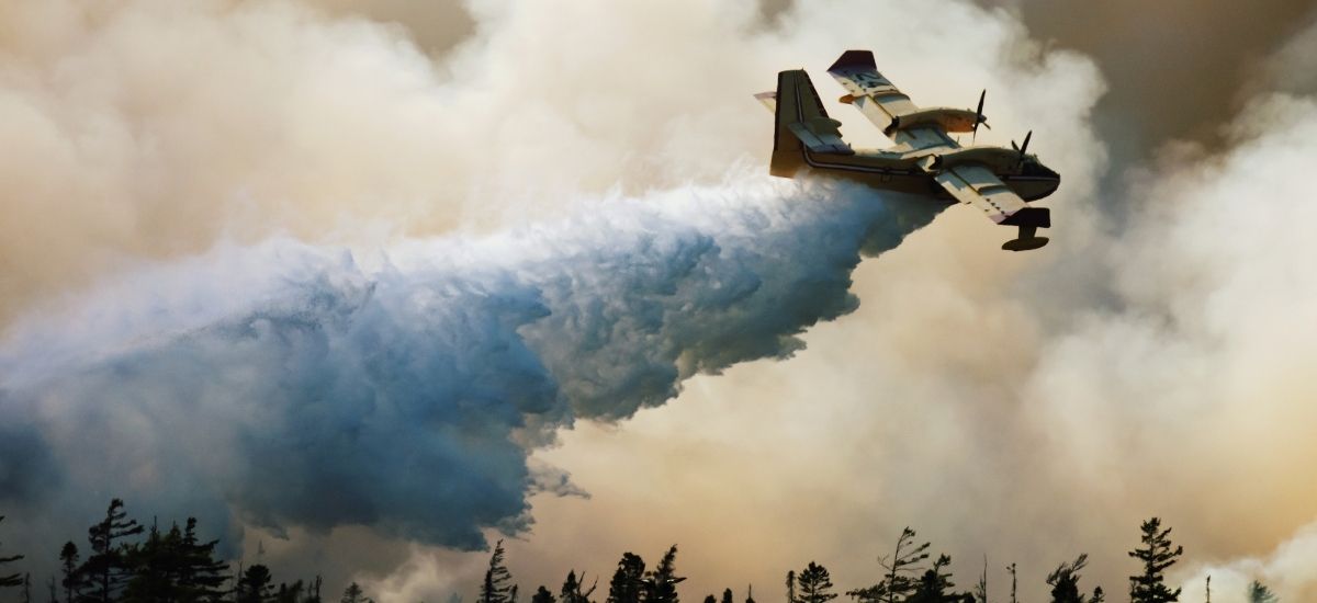 Airtanker dropping water on wildfire