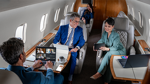 People on devices sitting in cabin