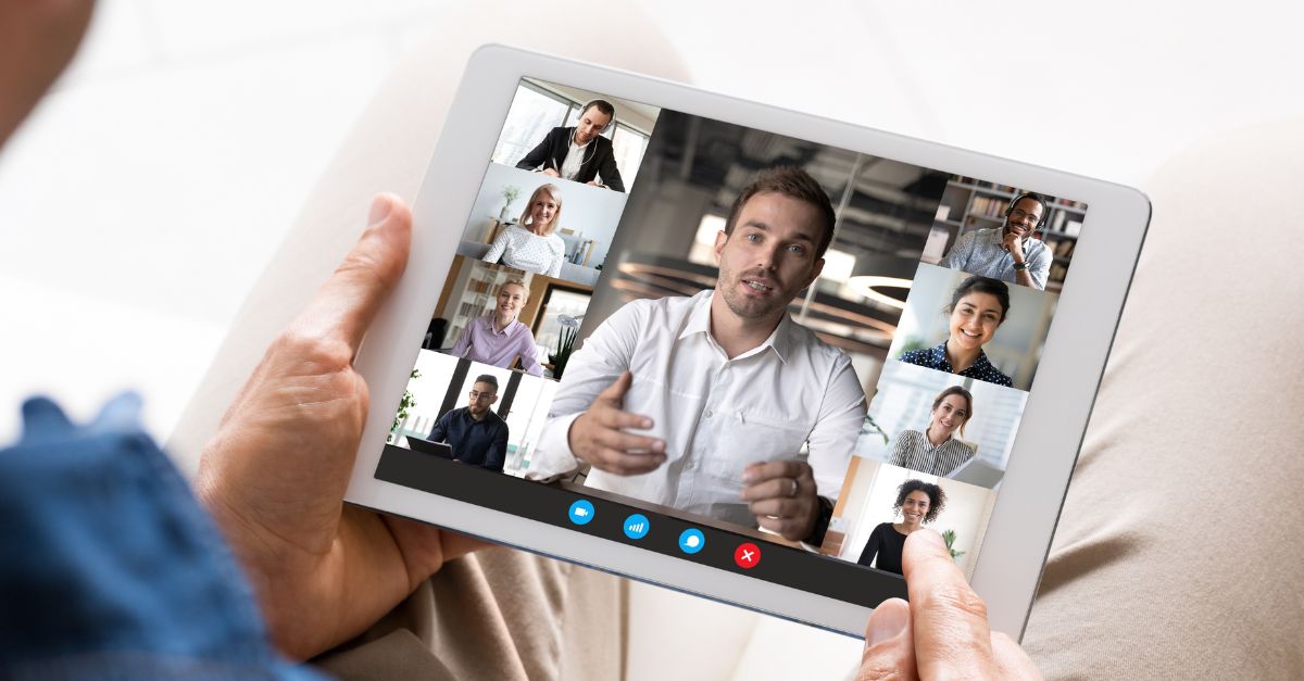 Person holding iPad on video meeting